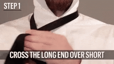 Man Tying Tie Long End Over Short End GIF