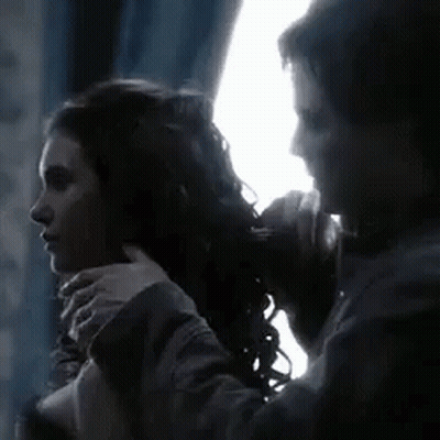 Man Tying Woman's Hair In Dark Room GIF