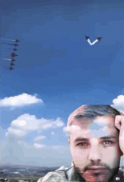 Man Under Blue Sky With Planes In Formation GIF