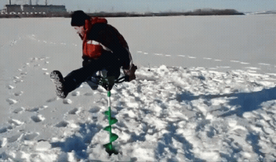 Man Using Ice Auger To Drill Hole In Snow GIF