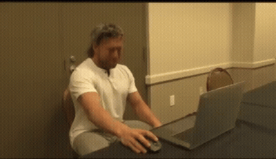 Man Using Laptop At Desk GIF
