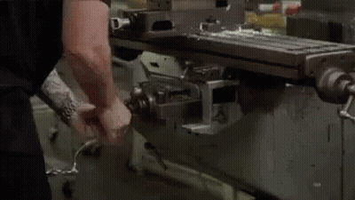 Man Using Machine To Cut Metal In Factory GIF