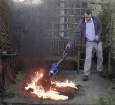 Man Using Vacuum Cleaner To Clear Fire GIF