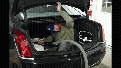 Man Using Vacuum In Car Trunk GIF
