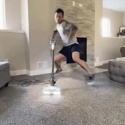 Man Vacuuming Living Room GIF