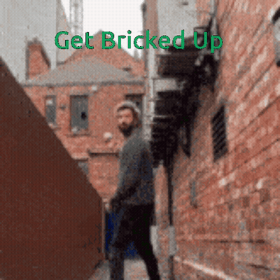 Man Walking Down Alleyway Saying Get Bricked Up GIF