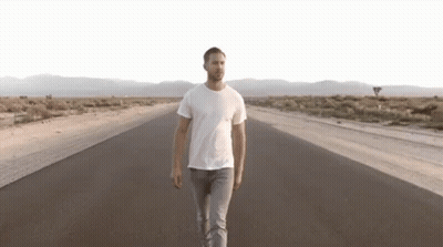 Man Walking Down Desert Road GIF