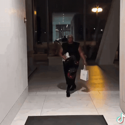 Man Walking Down Hallway Carrying Bag Saying SSS