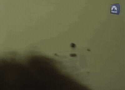 Man Walking Down Hallway Past Paramount Sign GIF