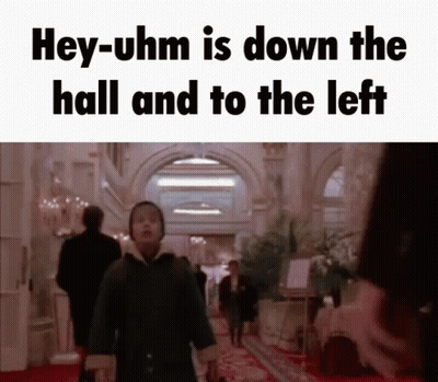 Man Walking Down Hallway Saying Hey-Uhm Is Down The Hall And To The Left GIF