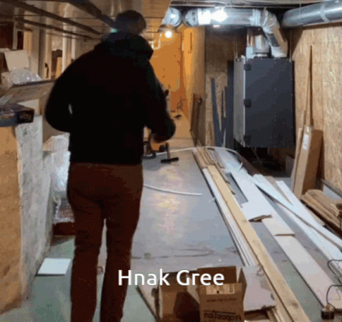 Man Walking Down Hallway With Hnak Gree GIF