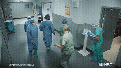 Man Walking Down Hallway With NBC Logo GIF
