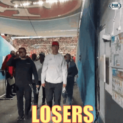Man Walking Down Hallway With Word Losers GIF