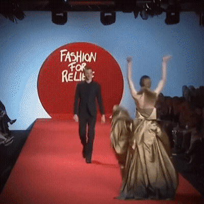Man Walking Down Red Carpet In Front Of Fashion For Relies Sign GIF