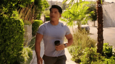 Man Walking Down Sidewalk With Coffee GIF