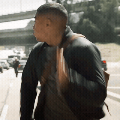 Man Walking Down Street With Backpack GIF