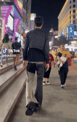 Man Walking Down Street With TikTok Sticker GIF
