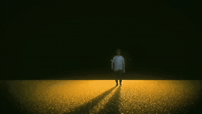 Man Walking In Field With Fire Explosion GIF