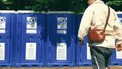 Man Walking In Front Of Blue Pixi Toilets GIF