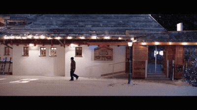 Man Walking In Front Of Building Sign GIF