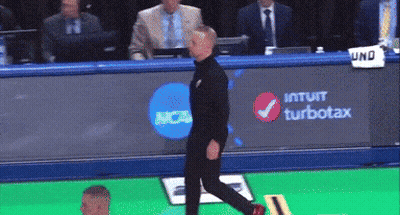 Man Walking In Front Of NCAA Banner GIF
