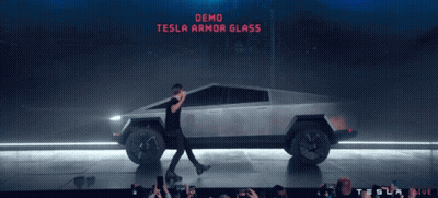 Man Walking In Front Of Tesla Car Saying Demo Tesla Armor Glass GIF