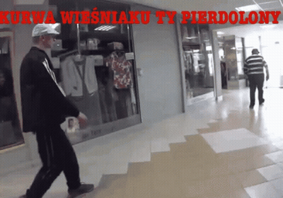 Man Walking In Hallway With Kurwa Wiesniaku Ty Pierdolony GIF