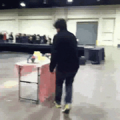 Man Walking In Room With Table And Chairs GIF