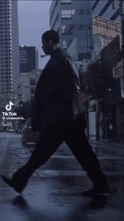 Man Walking On City Street With TikTok Watermark GIF
