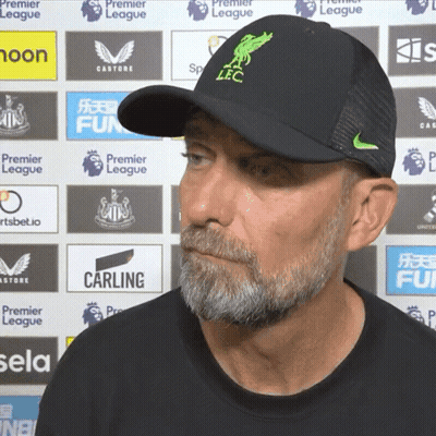 Man Walking On Soccer Field In Front Of Etihad Stadium Sign GIF