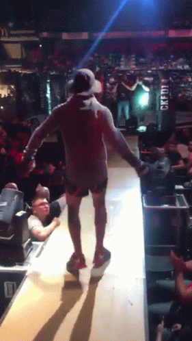 Man Walking On Stage With Credit Sign GIF