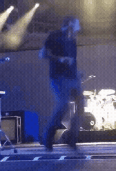 Man Walking On Stage With Drum Set GIF