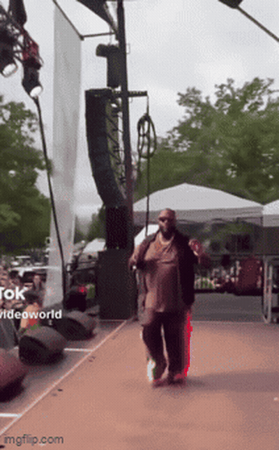 Man Walking On Stage With Videoworld Sign GIF