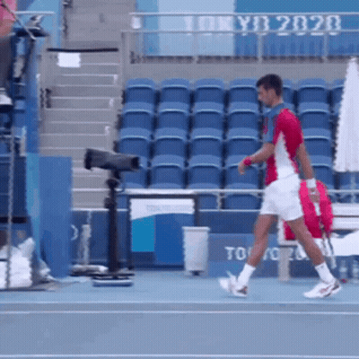 Man Walking On Tennis Court With Tokyo 2020 GIF