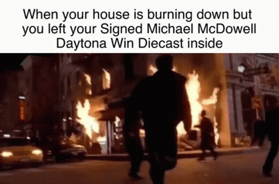 Man Walking Past Burning Building GIF