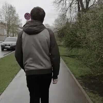 Man Walking Past No Parking Sign GIF
