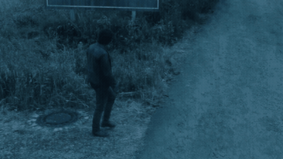 Man Walking Past Welcome To Silent Hill Sign GIF