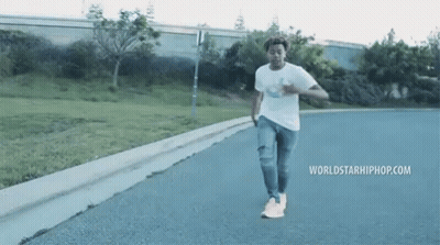 Man Walking Street With Worldstarhiphop.com GIF