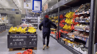 Man Walking Through Fruit And Vegetable Aisle GIF