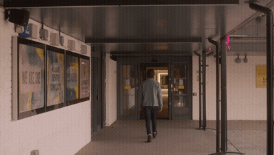 Man Walking Through Hallway We Are One Sign GIF