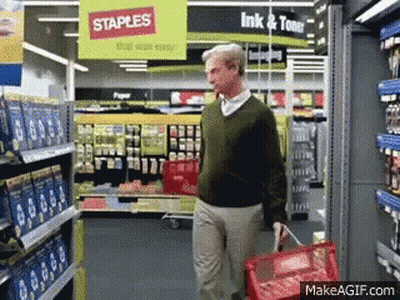 Man Walking Through Staples Store With Red Basket GIF