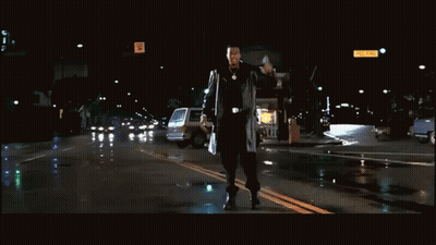 Man Walking With Freeway Sign GIF