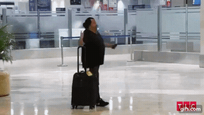 Man Walking With Suitcase In Airport GIF