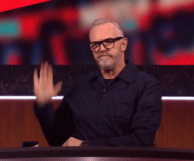 Man Waving Hand At Table GIF