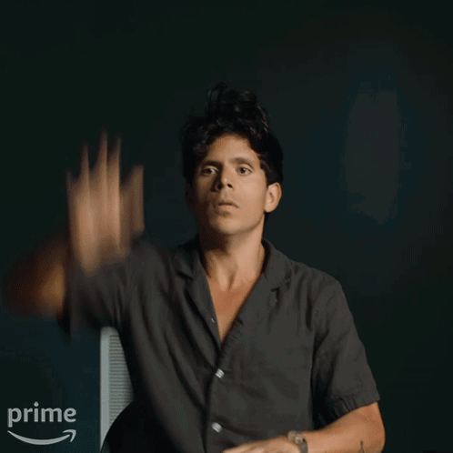 Man Waving Hand In Front Of Prime Sign GIF