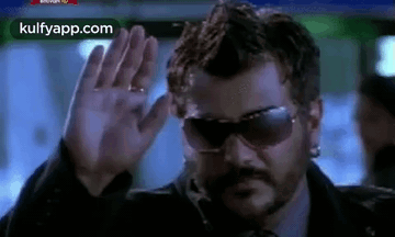 Man Waving Hand In Sunglasses GIF