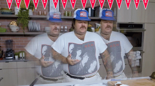 Man Wearing A.C.H. Shirt Standing In Kitchen GIF