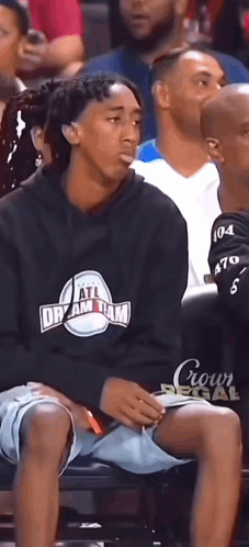 Man Wearing All Dream Team Sweatshirt Sits In Crowd GIF