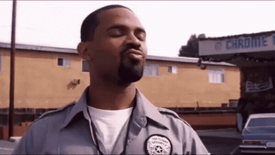 Man Wearing Apron In Front Of Open Store GIF