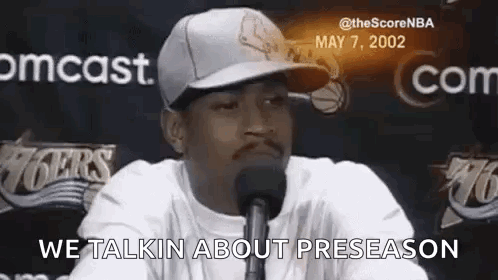 Man Wearing Baseball Cap Talking Into Microphone GIF